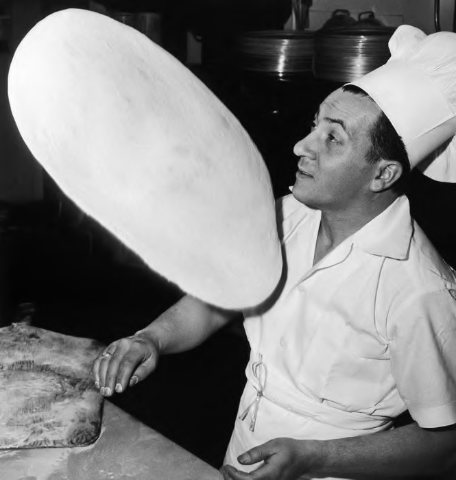 Italian pizza chef tossing dough